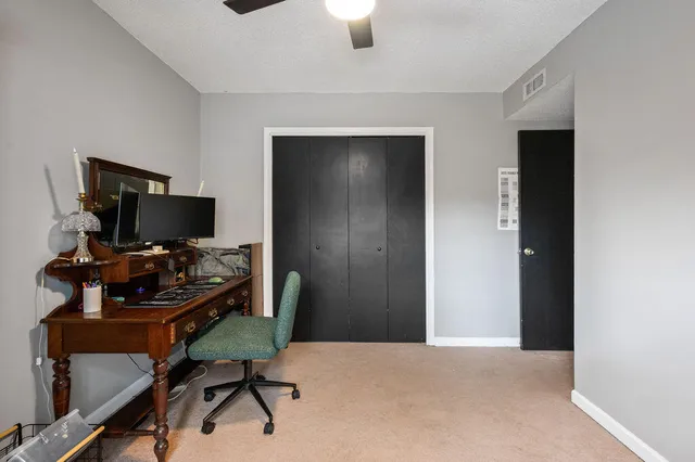 a workspace with a flat screen tv and a window
