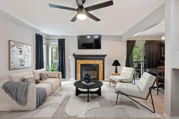 a living room with furniture fireplace and window