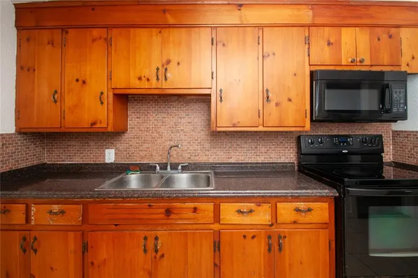 a kitchen with stainless steel appliances granite countertop a refrigerator and microwave