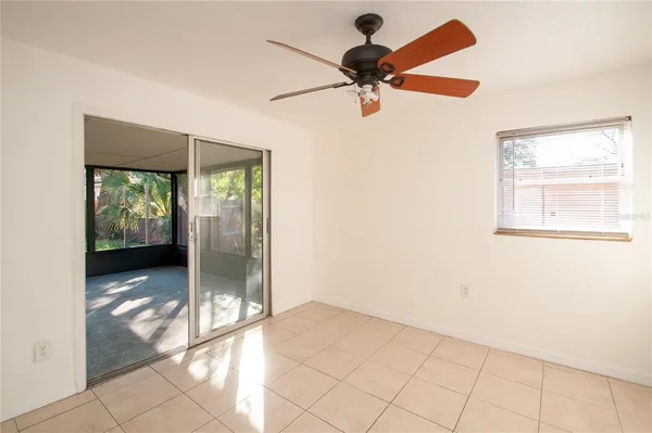 a view of a livingroom with a ceiling fan and window