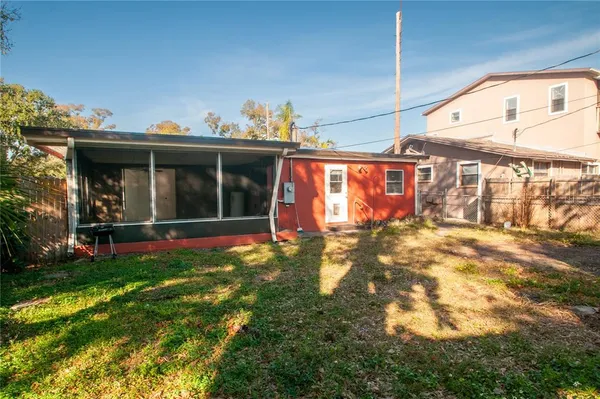 a view of a house with a backyard
