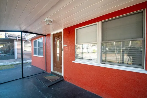 a view of an empty room with a floor to ceiling window and an outdoor view