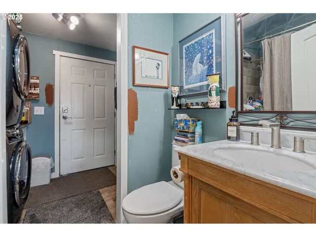 a view of a house with a yard and large tree