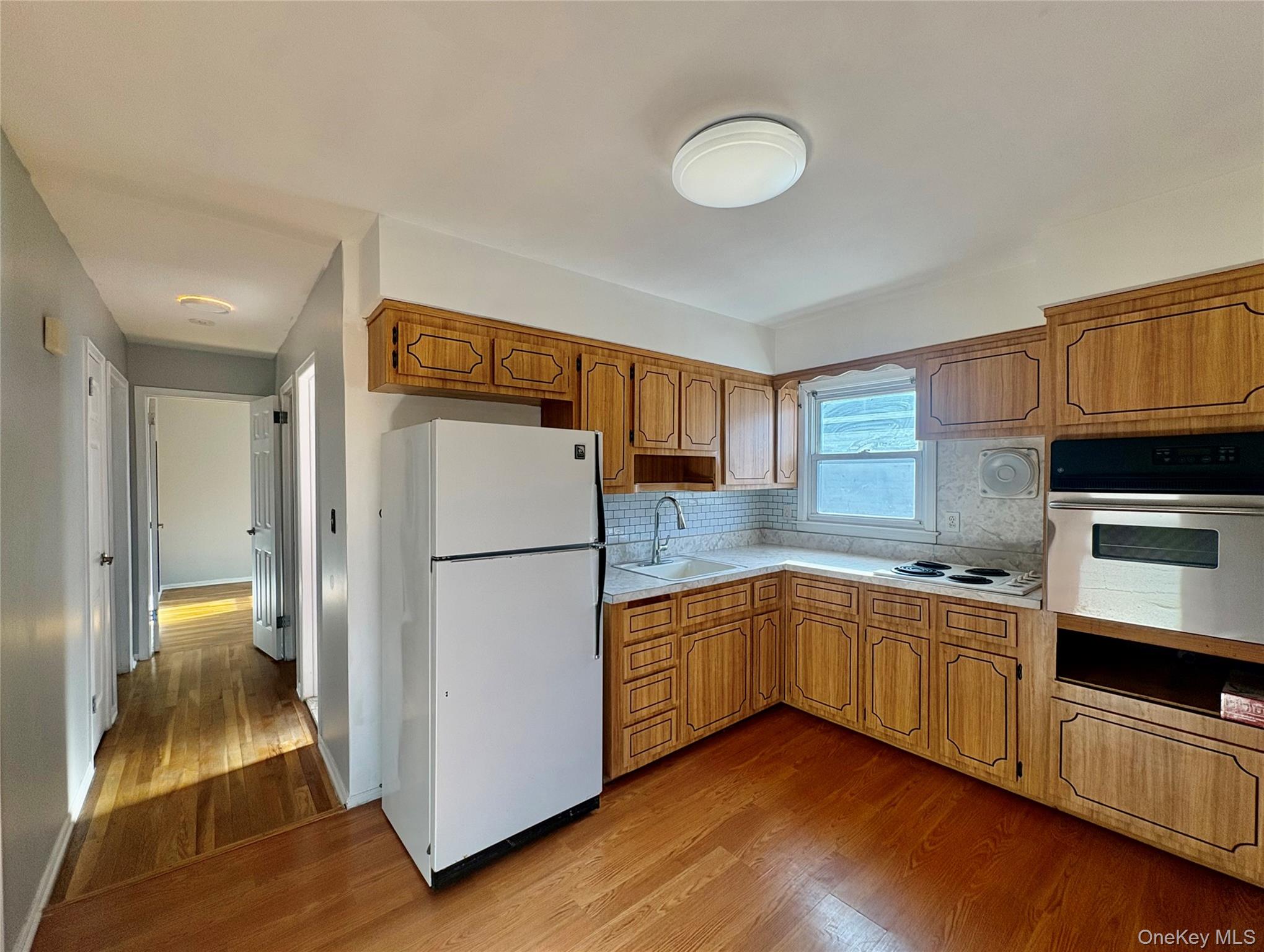 Undisclosed Address Valley Stream, NY 11581 - Photo 6 of 11 a kitchen with stainless steel appliances granite countertop a refrigerator a stove a sink and a microwave