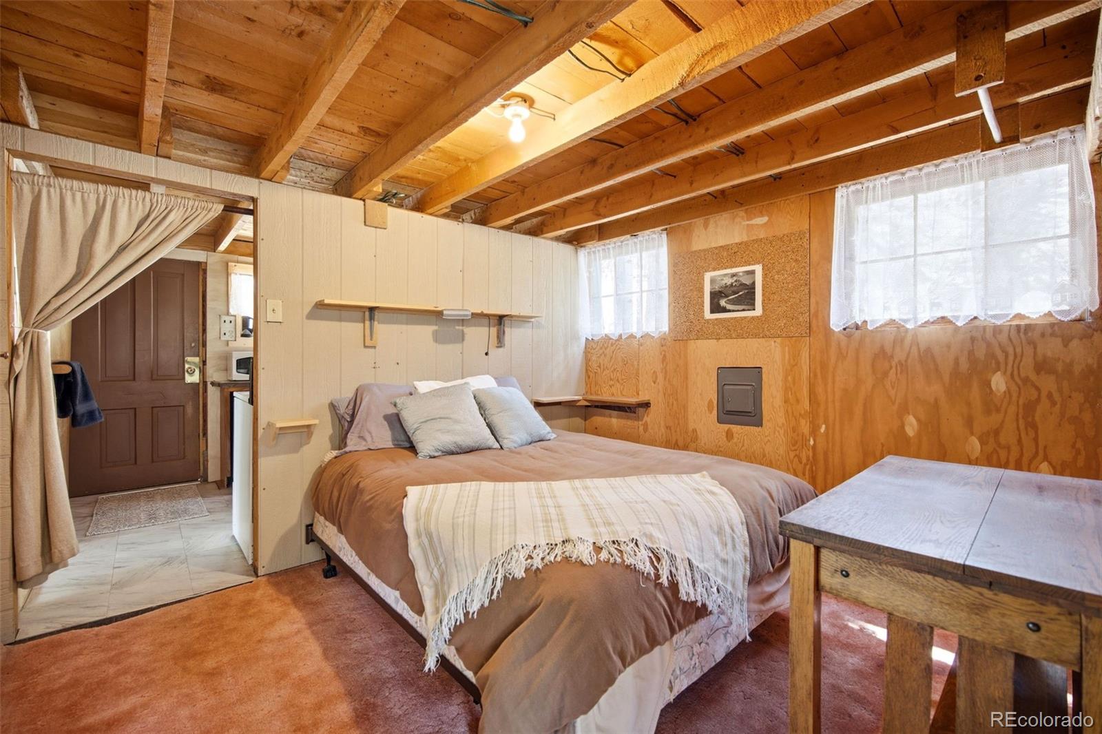 652 Payne Gulch Road Bailey, CO 80421 - Photo 20 of 33 a bed sitting in a bedroom next to a window