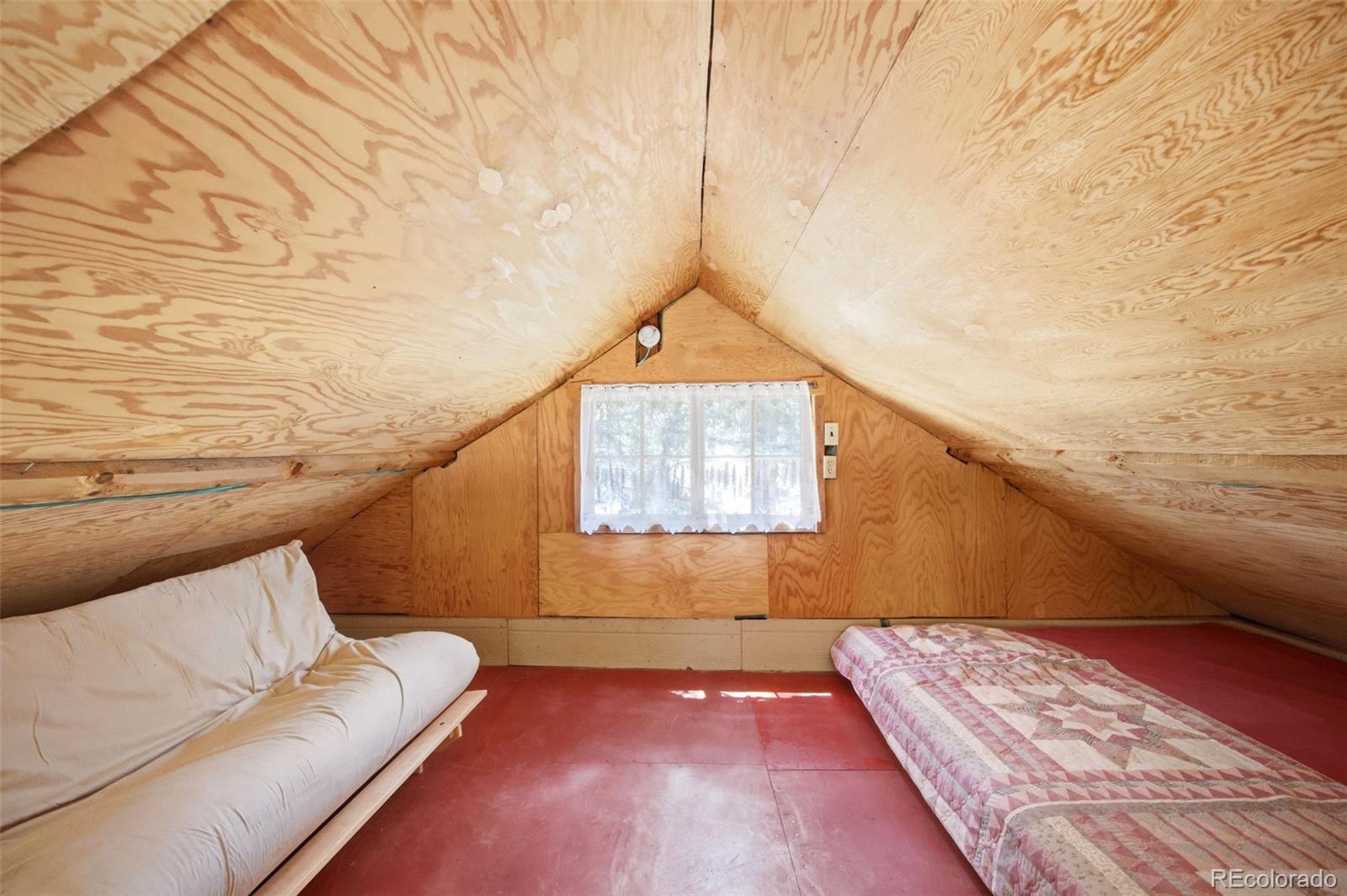 652 Payne Gulch Road Bailey, CO 80421 - Photo 22 of 33 a view of a room with wooden floor and chair