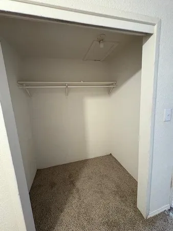 a view of storage and utility room with racks on the wall