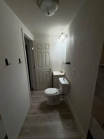 a bathroom with a toilet a sink and mirror