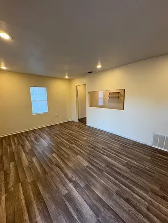 a view of an empty room and wooden floor