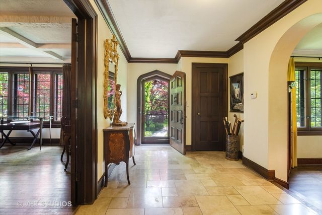 a view of a hallway with wooden floor and windows