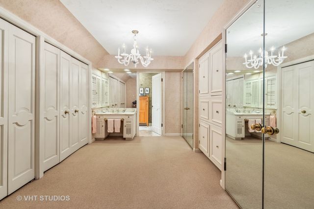 a bathroom with a double vanity sink a large mirror and a shower