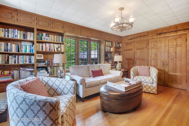 a living room with furniture and a bookshelf