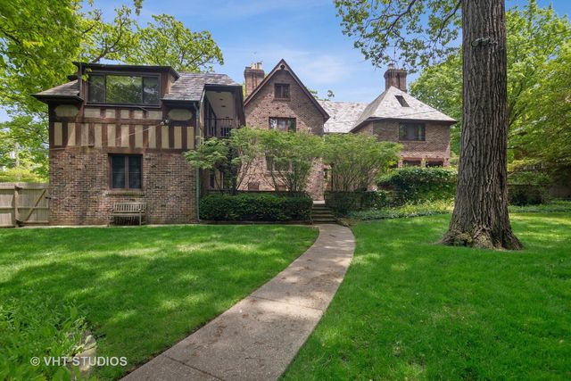 a front view of a house with yard and green space