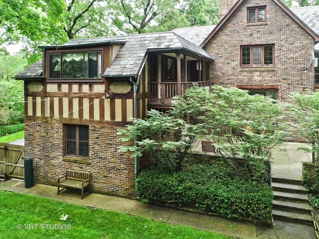 a view of a chairs and tables in the back yard of the house