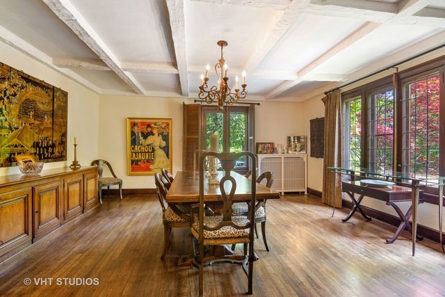 a view of a dining room with furniture large windows and wooden floor