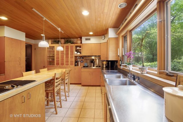 a large kitchen with lots of counter space and furniture