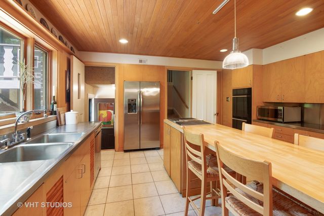 a kitchen with stainless steel appliances kitchen island granite countertop a sink and cabinets