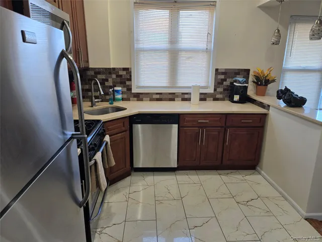 a kitchen with a sink a stove cabinets and a chairs