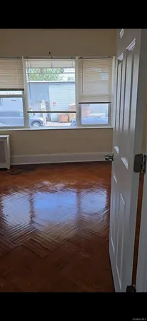 a view of a room with wooden floor