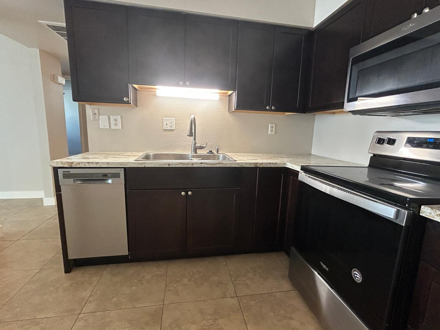 859 South Ext Road Mesa, AZ 85210 - Photo 7 of 19 a kitchen with a sink a stove and cabinets
