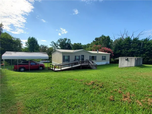 a bus parked in front of a house with a garden
