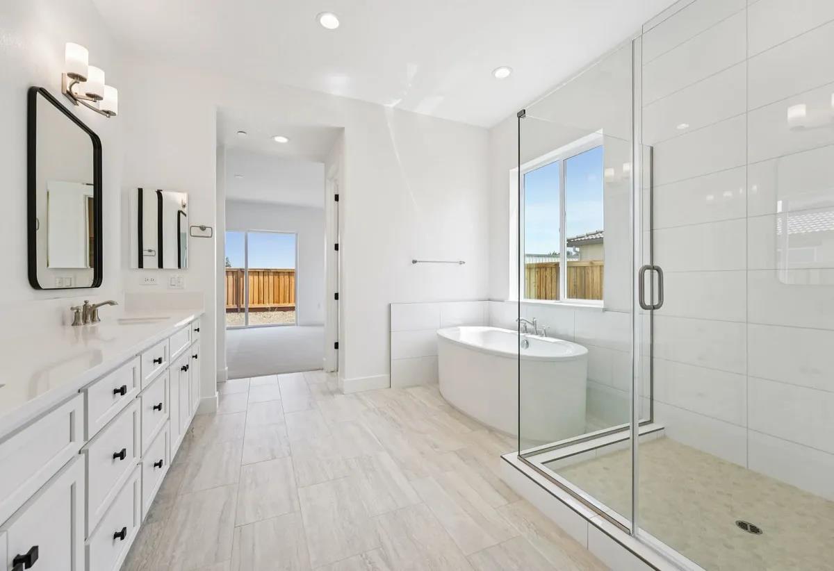 475 Trellis Way Brentwood, CA 94513 - Photo 11 of 16 a bathroom with a tub sink and mirror