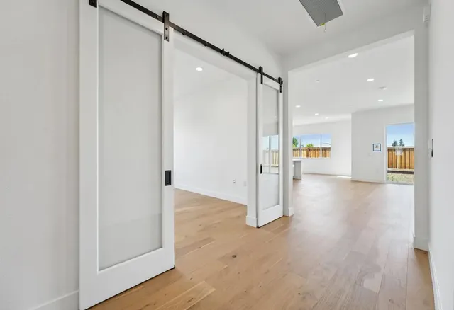 a view of a hallway with wooden floor