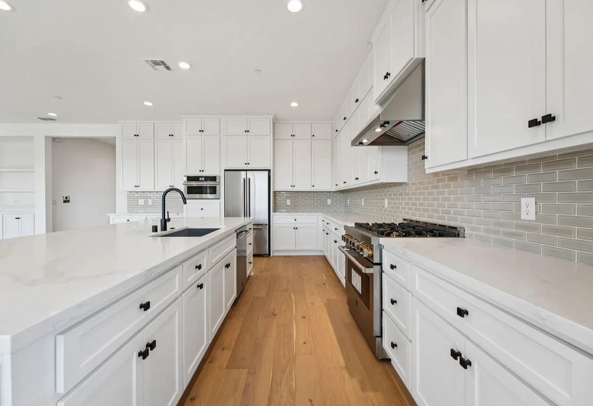 475 Trellis Way Brentwood, CA 94513 - Photo 5 of 16 a large kitchen with stainless steel appliances granite countertop a lot of counter space and wooden floors