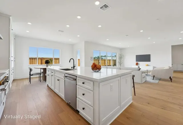 a kitchen with stainless steel appliances granite countertop a lot of counter top space and cabinets