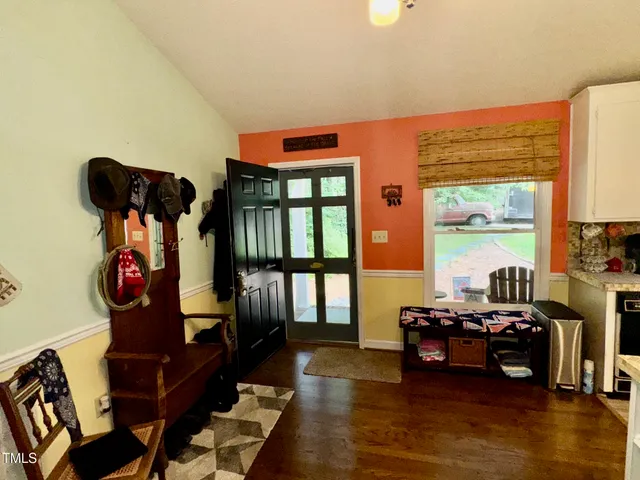 a living room with furniture and a floor to ceiling window