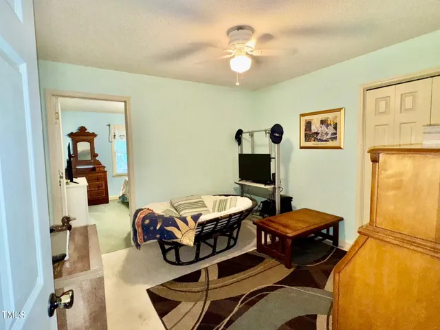 a bedroom with bed and a chandelier