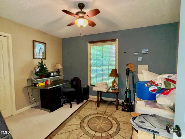 a bedroom with bed and a chandelier