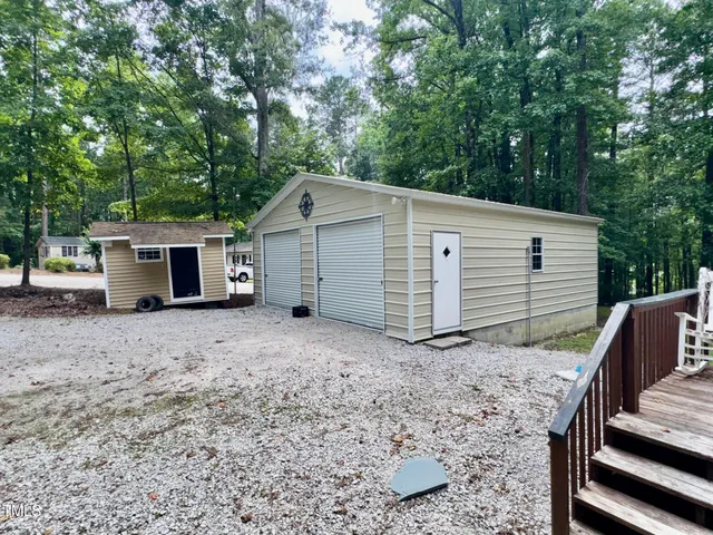 a view of a house with a yard and garage