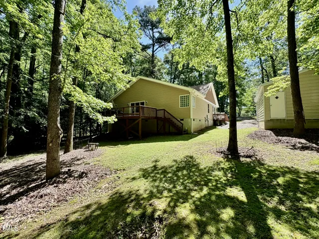 a yellow house with trees in front of it