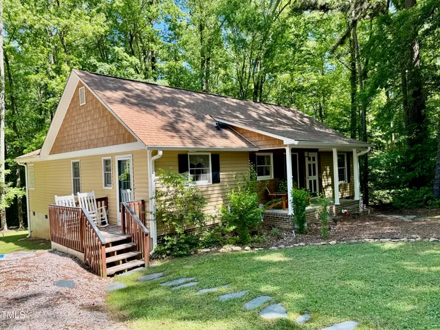 a backyard of a house with table and chairs