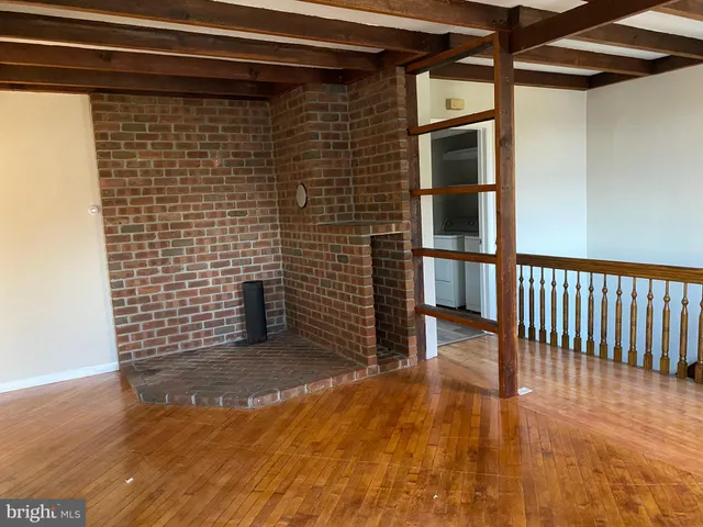 a view of a door and wooden floor