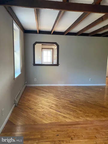 a view of a room with wooden floor