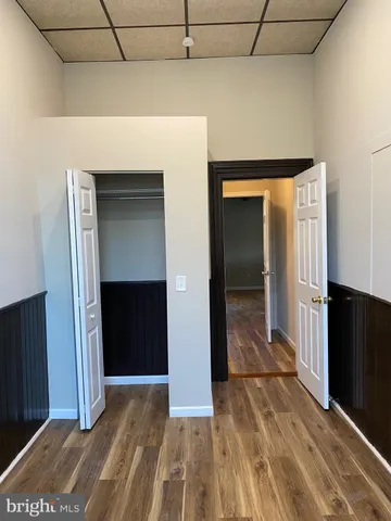 a view of hallway with wooden floor