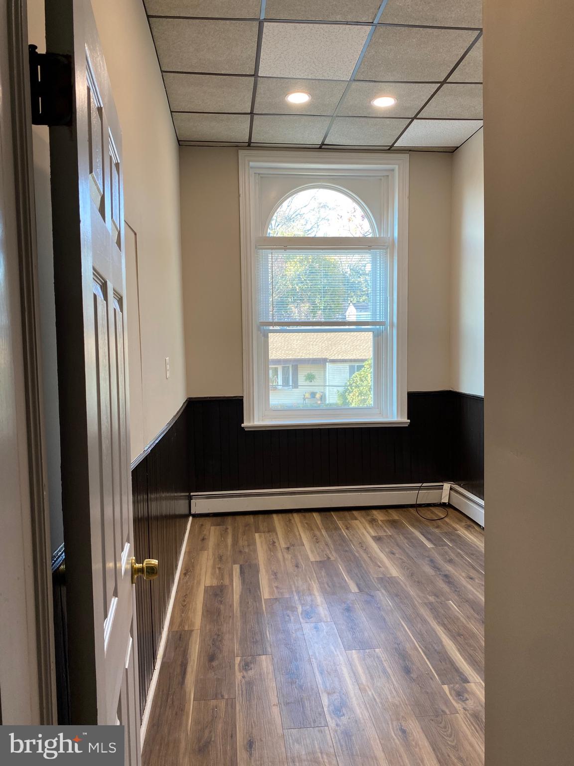 327 South Church Street, Unit 1 Spring City, PA 19475 - Photo 32 of 36 a view of an empty room with wooden floor and a window