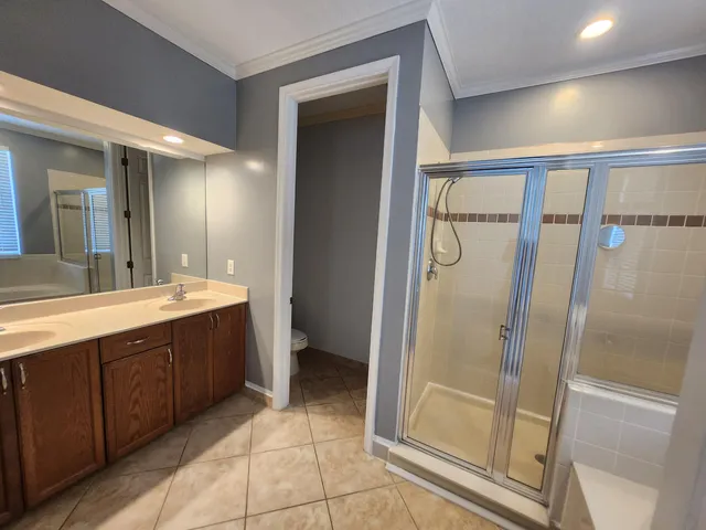 a view of empty room with wooden floor and windows