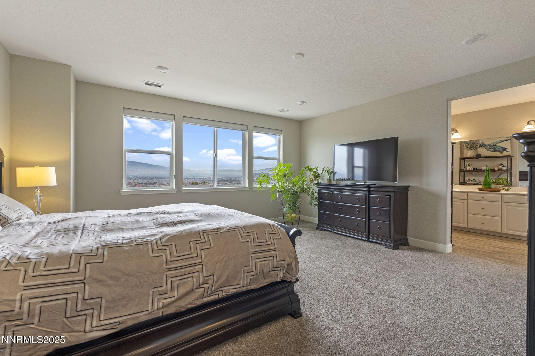 10245 Mother Lode Drive Reno, NV 89521 - Photo 28 of 67 a bed sitting in a spacious bedroom next to a window