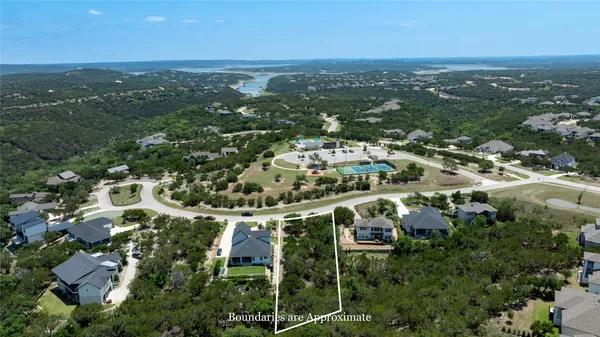 an aerial view of residential houses with city view