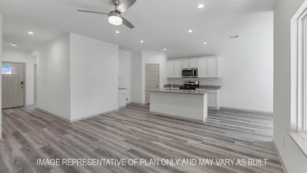 a view of kitchen with microwave and cabinets