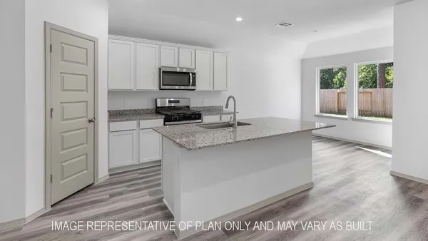a kitchen with stainless steel appliances granite countertop a sink stove and microwave
