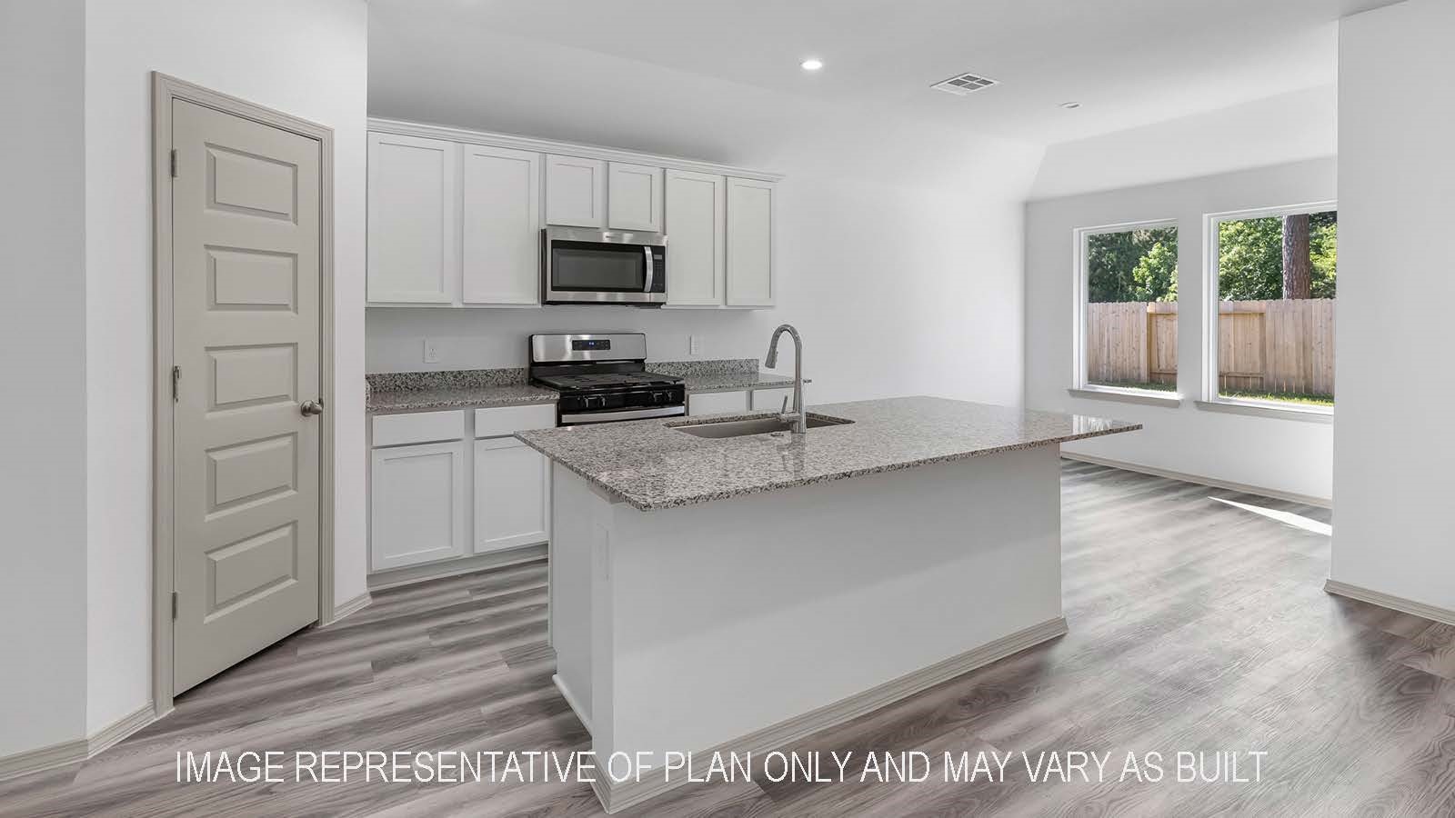 5695 Spoonbill Lane Orange, TX 77632 - Photo 5 of 22 a kitchen with stainless steel appliances granite countertop a sink stove and microwave