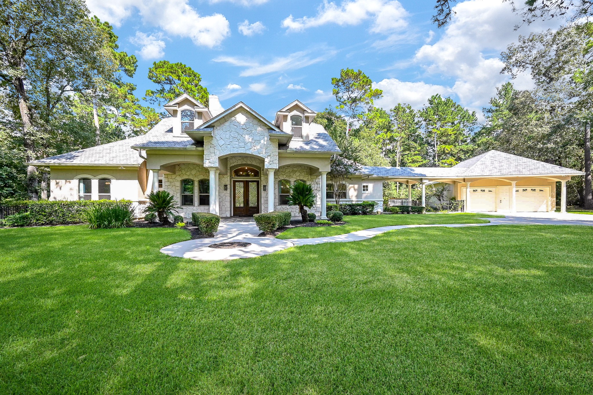a front view of a house with a garden and plants