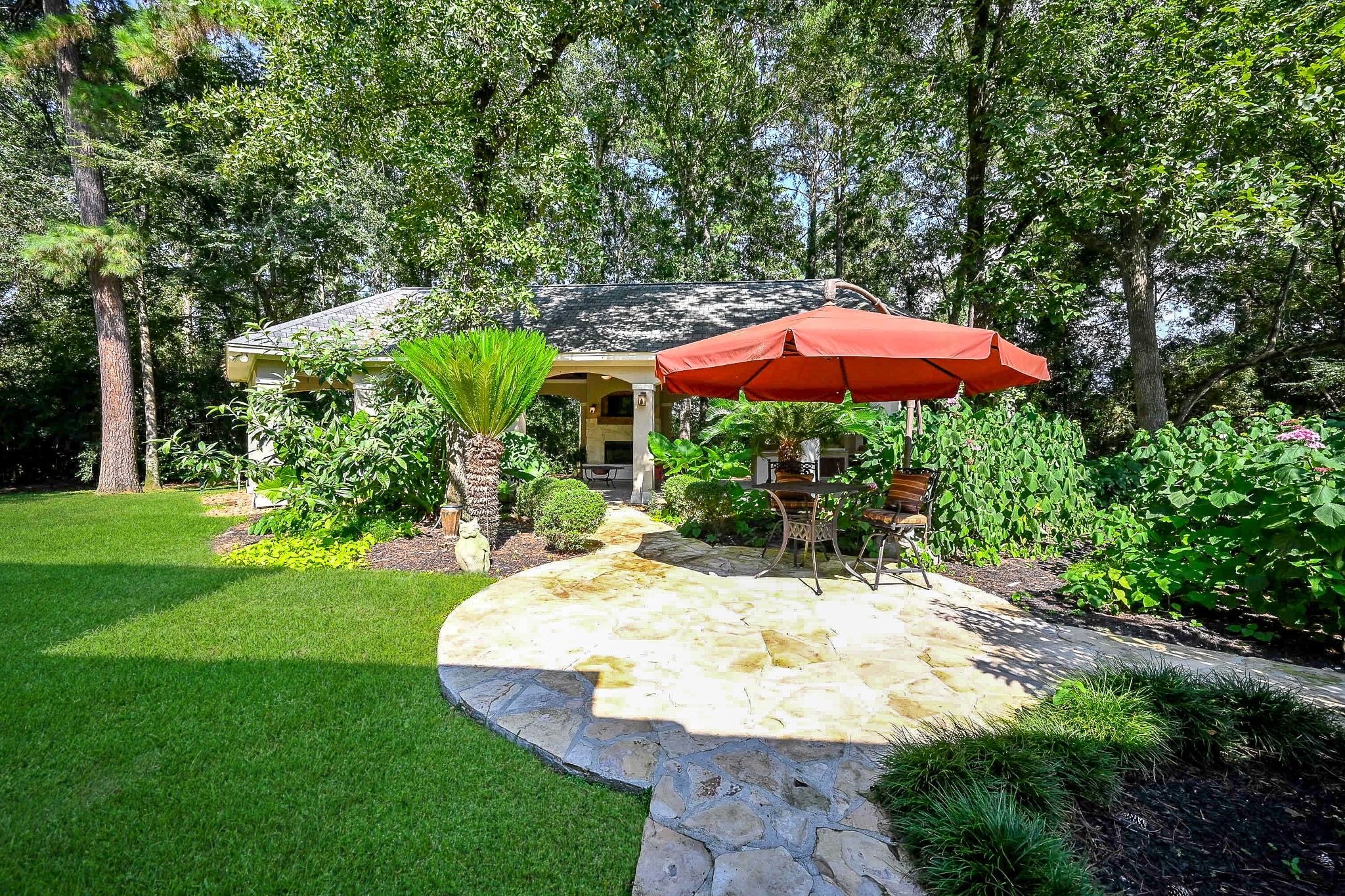 23914 Clouds Rest Magnolia, TX 77355 - Photo 5 of 50 a view of a patio with a table and chairs under an umbrella