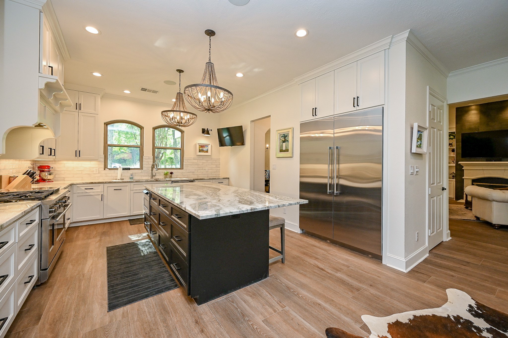23914 Clouds Rest Magnolia, TX 77355 - Photo 6 of 50 a kitchen with stainless steel appliances granite countertop a stove and cabinets