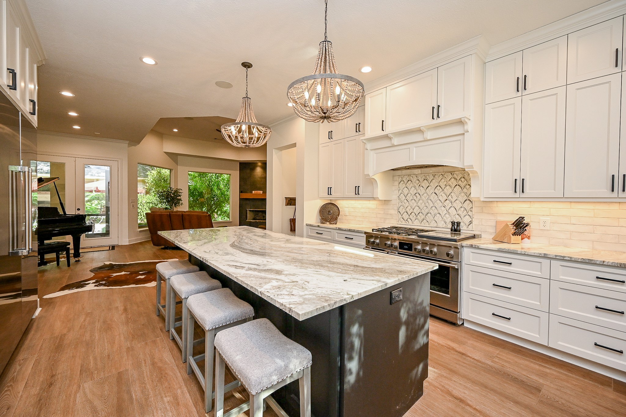 23914 Clouds Rest Magnolia, TX 77355 - Photo 8 of 50 a kitchen with a stove a chandelier and wooden cabinets