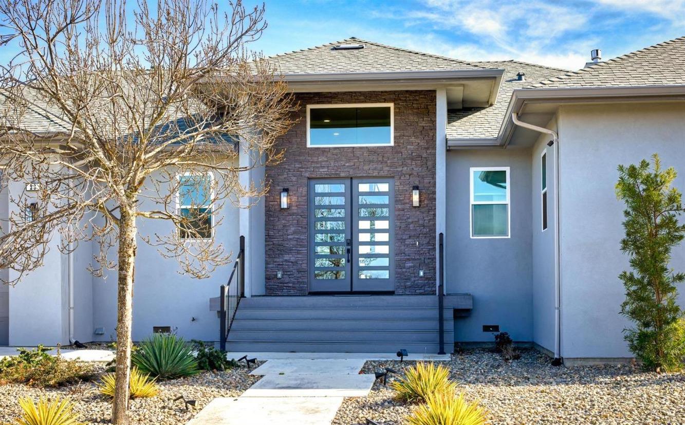a front view of a house with a garden